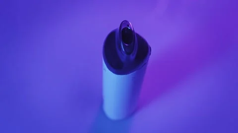 Modern E-Cigarette with Swirling Vapor on a Purple Background 스톡 동영상 329681237