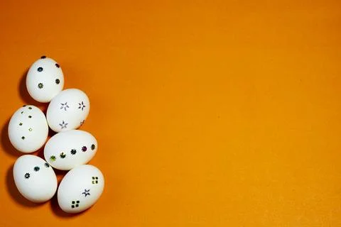 Modern Easter Eggs with Sparkly Decorations on Orange Background Stock-Fotos