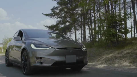 Modern electric car riding on road Stock Footage