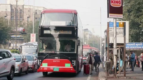A modern electric double decker public bus departing from the bus stop, Mumbai Stock Footage 327133893