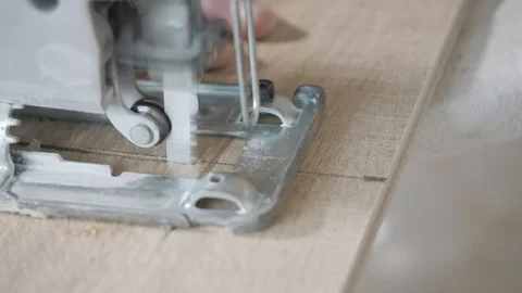 Modern electric jigsaw cuts thin brown board close view Stock Footage 106376836