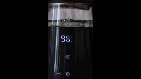 Modern electric kettle with touch controls boiling water to 100 degrees. Stock Footage 342487963
