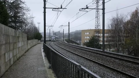 Modern electric light rail train passing on railway tracks Stock Footage 345946166