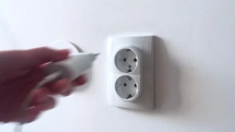 A modern electric outlet designed for easy charging with a cable and Stock Footage 282652617