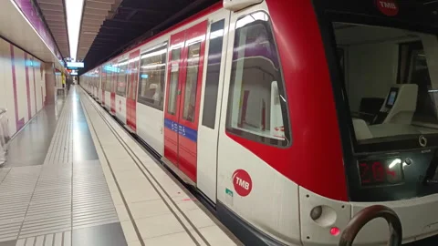 Modern electric subway train leaving the underground metro station in Barcelona Stock Footage 328664856