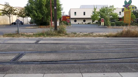 Modern electric train passing by town 스톡 동영상 112874426