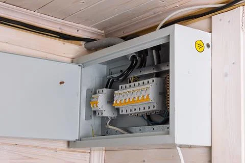 A modern electrical distribution board with open metal door reveals neat wi.. 库存照片