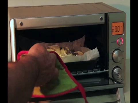 Modern electrinic oven. Someone is opening the door and checking if fish piaces Stock-Footage 69749583