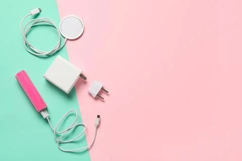 Modern electronic device charging accessories flat lay with power bank, USB c Stock Photos