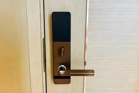 Modern electronic door lock on a light wood door. Stock-Fotos