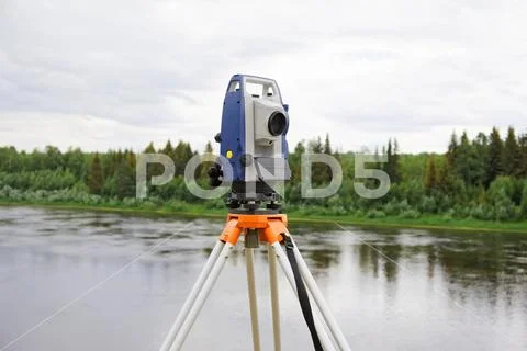 Modern electronic tachymeter mounted on tripod Stock Photos