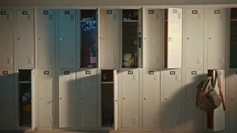 Modern Elementary School Corridor with Open Lockers Revealing Everyday Student Stock Footage 342024961