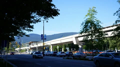 Modern Elevated Railway and City Traffic with Mountain View in British Columb Stock Footage 338054902