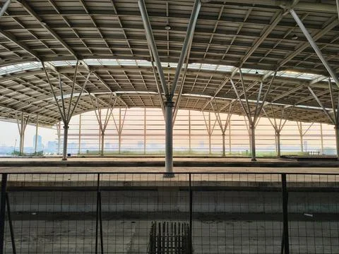 Modern elevated train station platform architecture with steel roof. Stock Photos