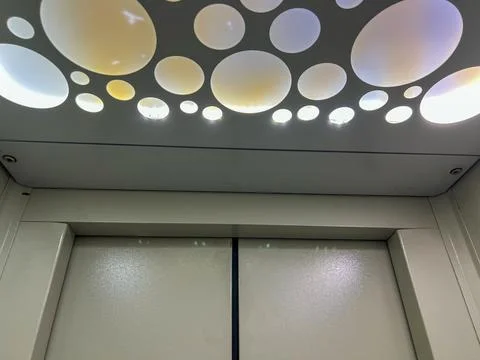 Modern elevator ceiling lights creating a circle pattern design Stock Photos