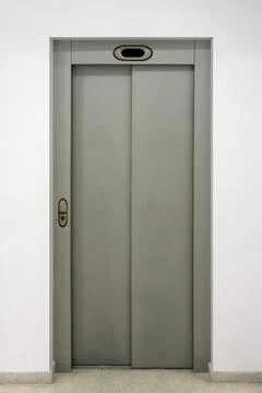 Modern elevator with closed doors in the wall Stock Photos