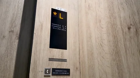 Modern Elevator Digital Display and Floor Indicator on Wood Panel Stock Footage 344948272