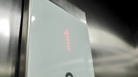 Modern Elevator Display Panel - Red LED Numbers Indicating Floor Movement - 4K Stock Footage 300946488