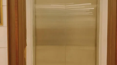 Modern elevator doors closed in a contemporary hotel or office building interior 库存影片 343421026