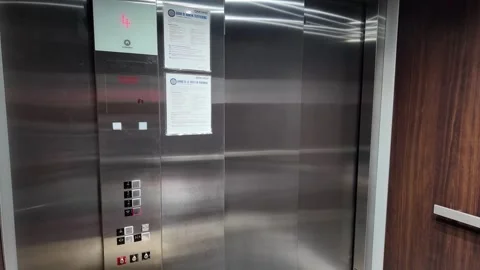 Modern elevator doors open to a clean hallway, close Stock Footage 340428684