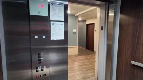 Modern elevator doors open to a clean hallway environment Stock Footage 340429619