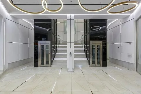 Modern elevator entrance in a sleek building lobby Stock Photos