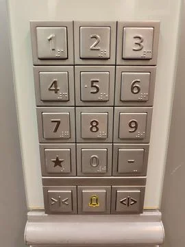 Modern elevator keypads blend numbers and symbols for improved functionality and Stock Photos