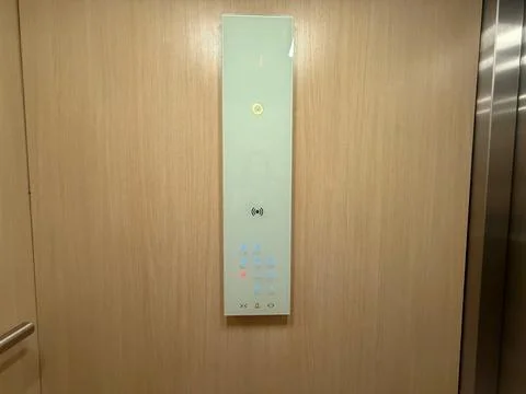 Modern elevator panel with illuminated floor buttons on wooden wall interio.. Stock Photos