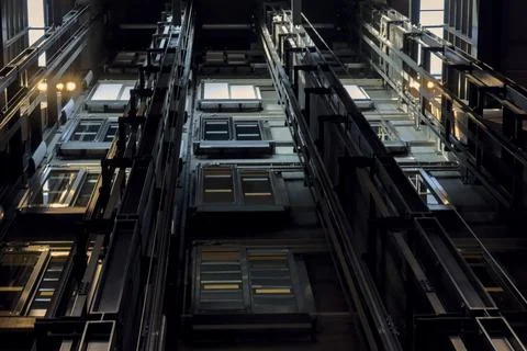 Modern elevator shaft mechanism with guide rails and doors inside ECS. Stock Photos