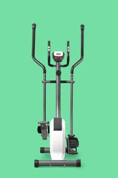 Modern elliptical machine on green background Stock Photos