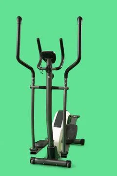 Modern elliptical machine on green background Stock Photos