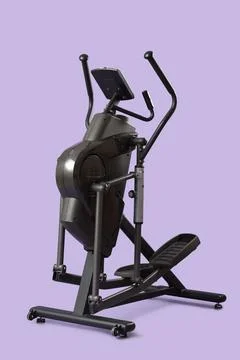 Modern elliptical machine on lilac background Stock Photos