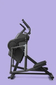 Modern elliptical machine on lilac background Stock Photos