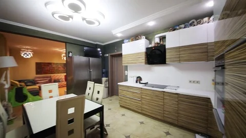 Modern empty kitchen with dinner table, fridge in apartment Video stock 80530912