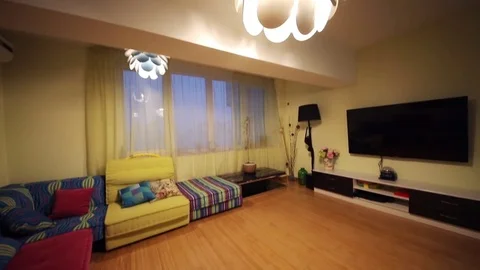 Modern empty living room with many bright sofas, tv in apartment Stock Footage 80530902