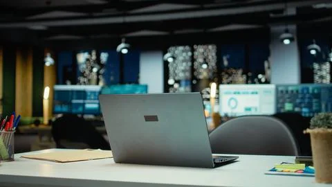 Modern empty office glows with performance metrics and forecasting graphs Stock Photos