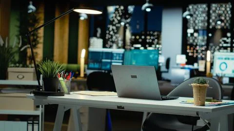 Modern empty office glows with performance metrics and forecasting graphs Stock Photos