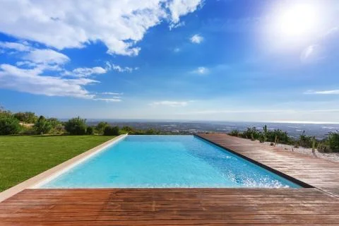 Modern endless infinity pool. With views of landscape. Stock Photos