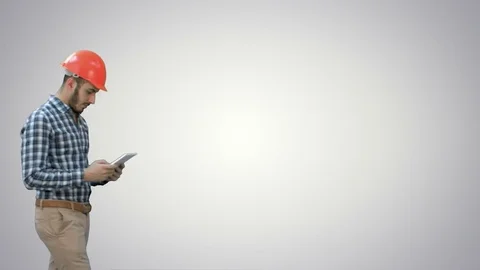 Modern engineer using a wireless tablet to check construction project on white Vídeo Stock 73634491