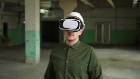 A modern engineer wearing virtual reality glasses inspects a construction site Stock Footage 152755115