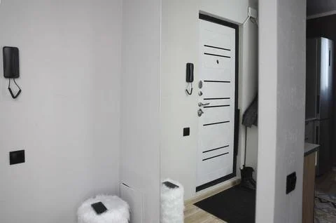 Modern entryway interior with closed white front door, black hardware, home Stock Photos