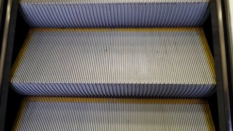 Modern Escalator Design with Metallic Steps and Yellow Safety Lines for Urban Stock Footage 327636994