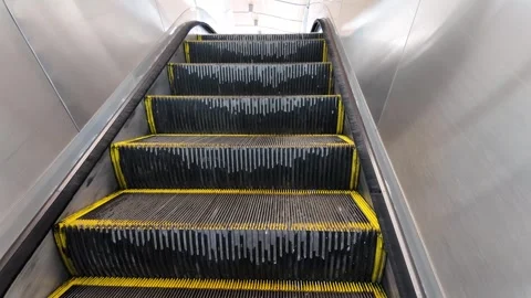 Modern Escalator Steps in Motion at a Shopping Mall Closeup Stock Footage 257868647