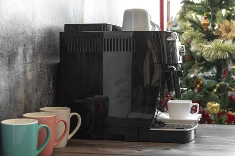 Modern espresso coffee machine with a cup in the interior of the kitchen. Stock Photos