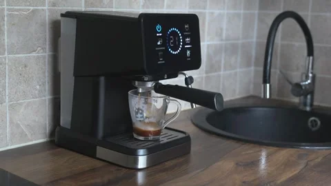 Modern espresso machine with digital display on kitchen counter Stock Footage 338176103