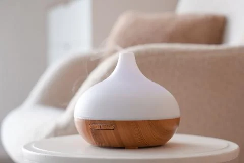 Modern essential oil diffuser with mist emitting, aromatherapy and relaxation Stock Photos