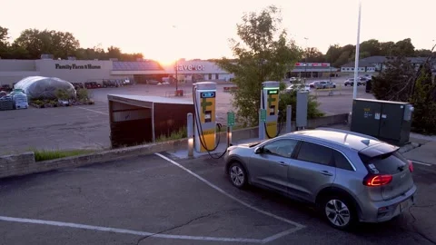 Modern EV charging in small town of Clare in USA, Michigan. Aerial ascend 스톡 동영상 249813718