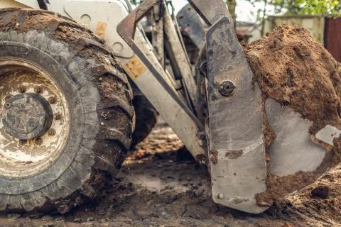 The modern excavator performs excavation work on the construction site. View on Stock Photos