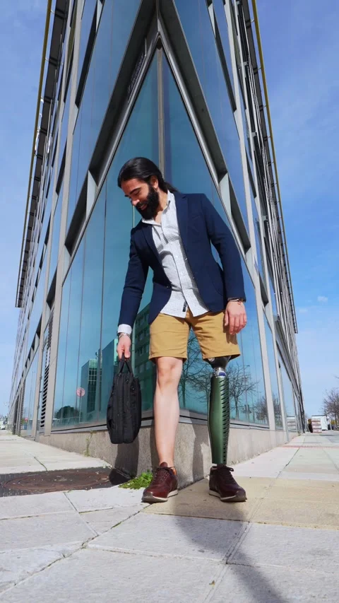 Modern Executive with Prosthetic Limb Posing at Urban Glass Stock Footage 264058912