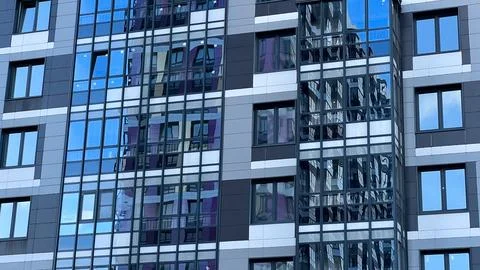 Modern facade of a new residential complex, blue glass facade glazing Stock Photos